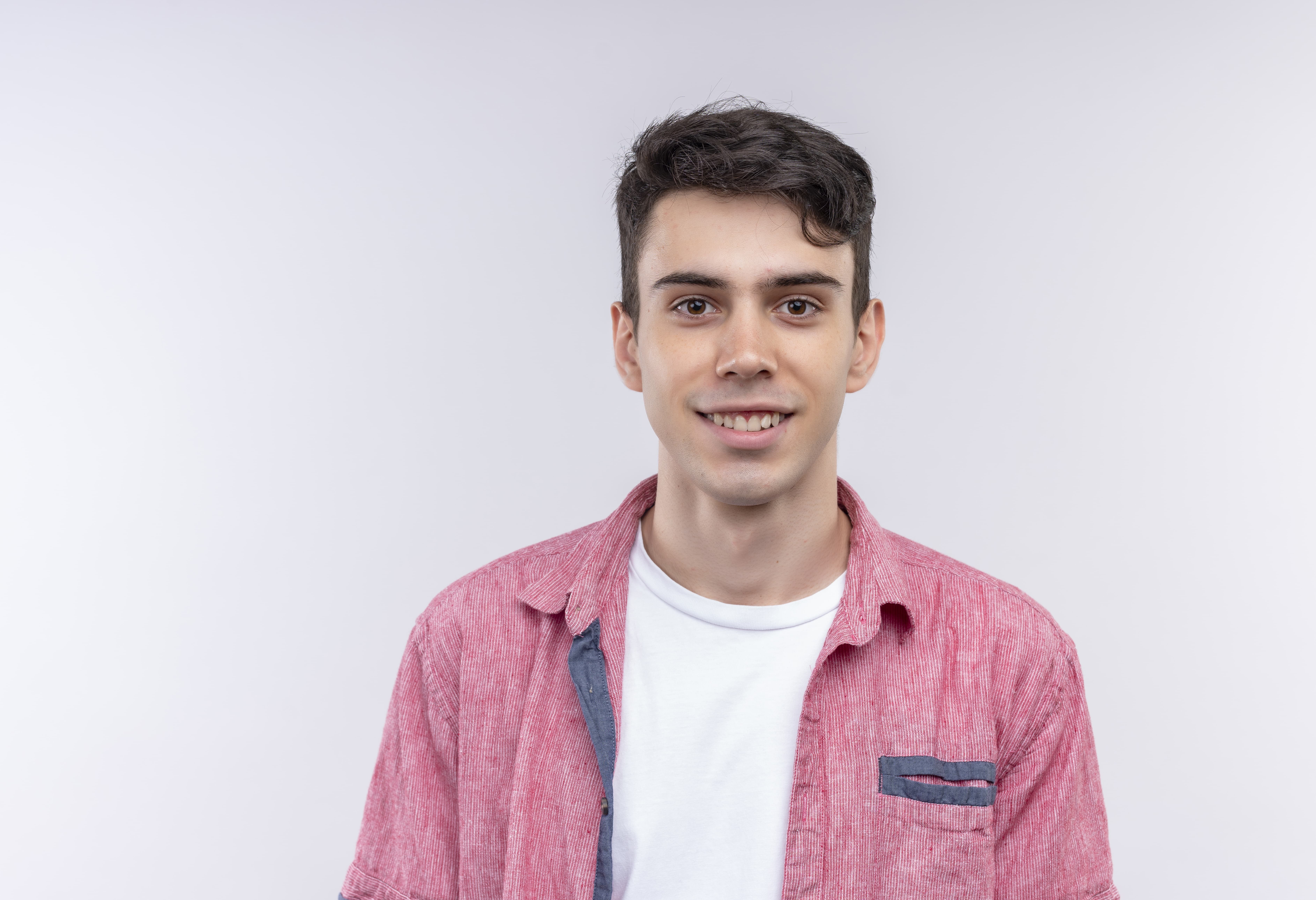 smiling caucasian young guy wearing pink shirt isolated white background  1 